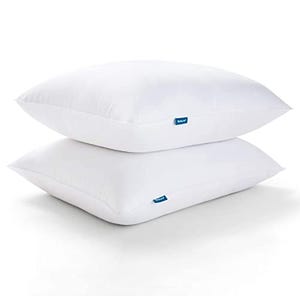 Two queen-size white pillows stacked on top of each other with blue tags on the sides.
