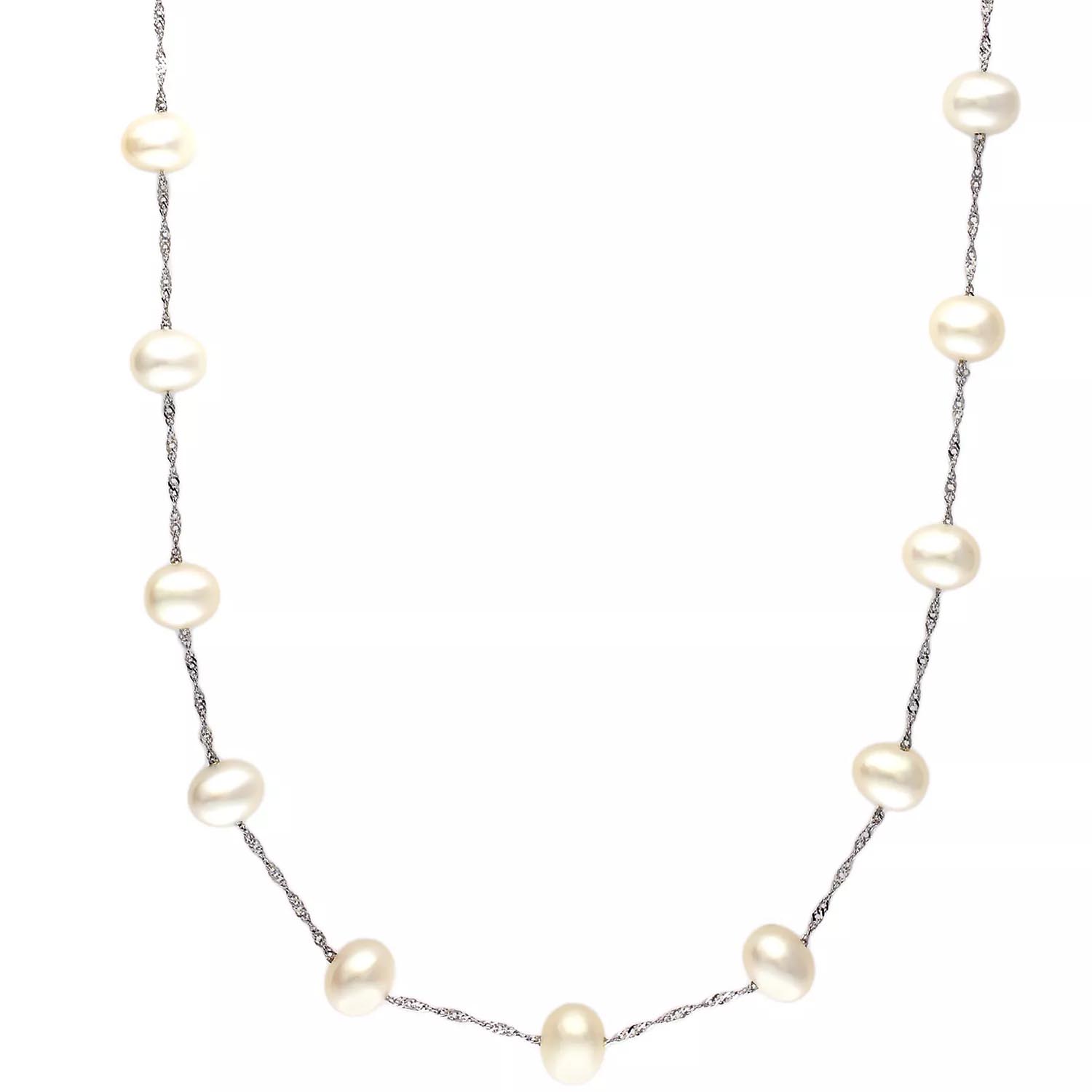 A delicate necklace featuring evenly spaced white pearls on a twisted silver chain.