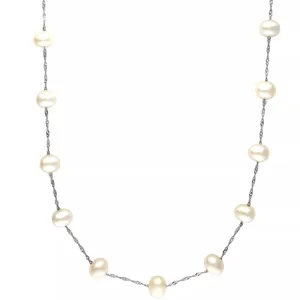 A delicate necklace featuring evenly spaced white pearls on a twisted silver chain.