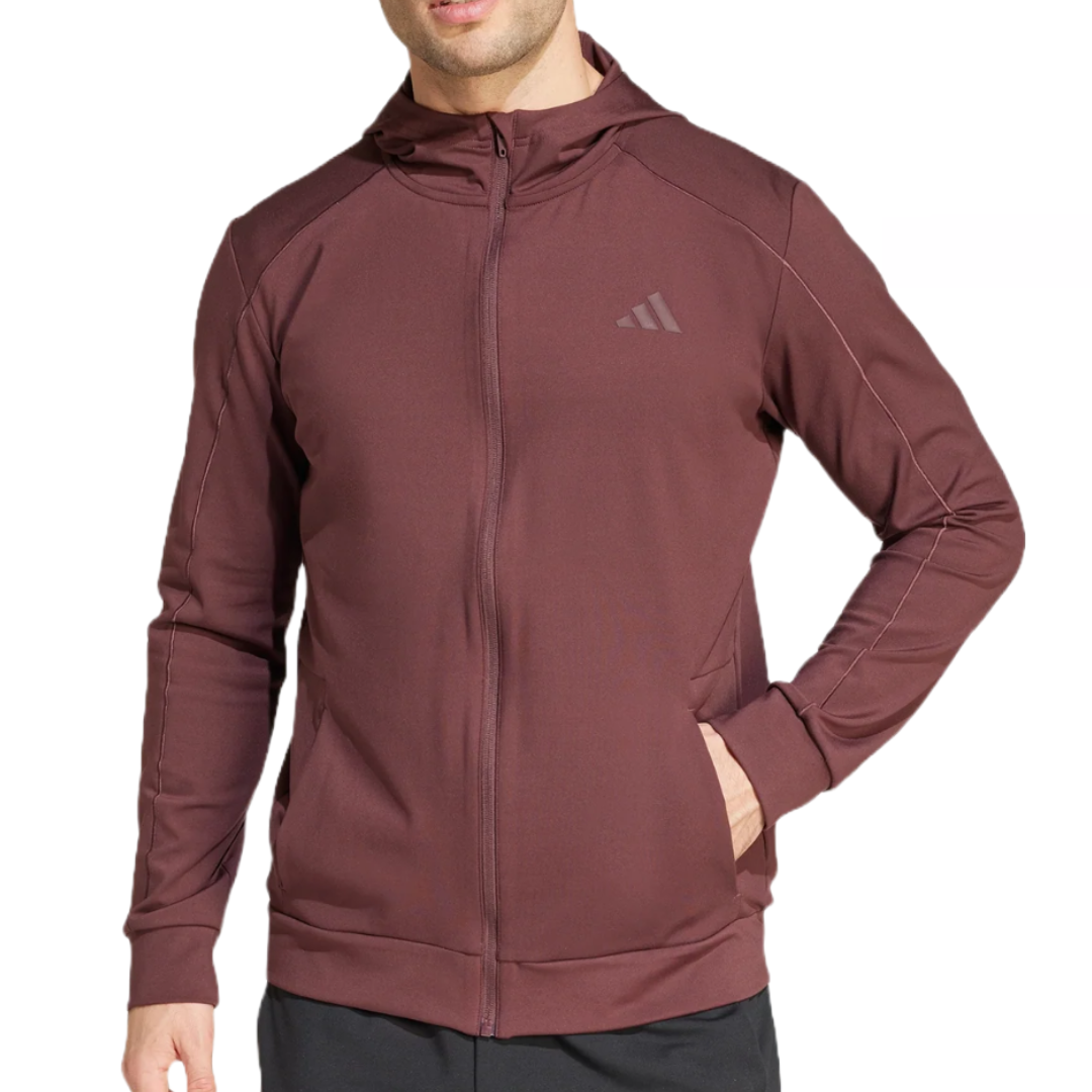 The Adidas Puremotion Jacket is a maroon hoodie with a full front zipper, featuring the Adidas logo on the chest. It has long sleeves and pockets, offering a sleek and athletic look.