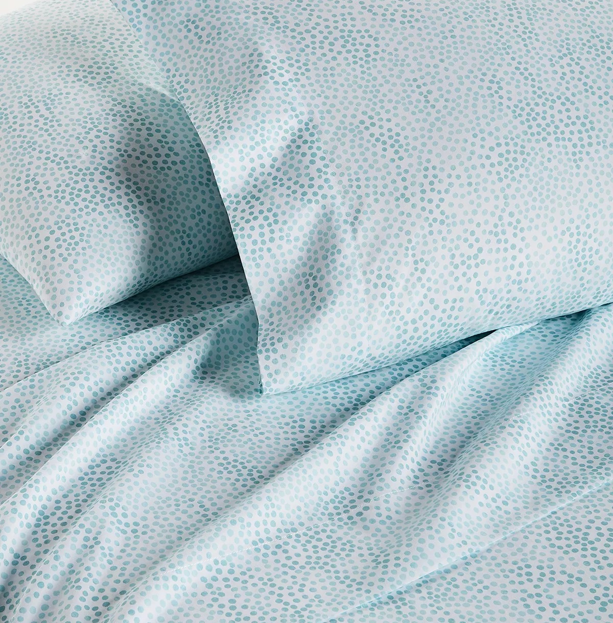 Light blue bedding with a small, darker blue dot pattern.