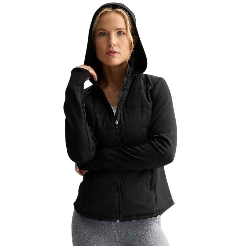 A person wearing a black zip-up hooded jacket with thumb holes and pockets, paired with light gray leggings.