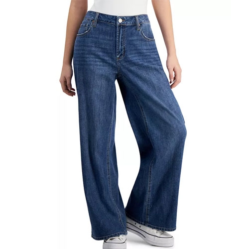A pair of wide-leg denim jeans with a light to medium wash and a high waist, worn with white sneakers.