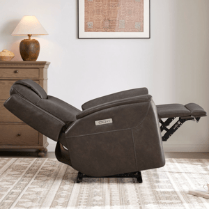 A brown reclining chair is shown in a living room setting, partially reclined next to a wooden dresser and a table lamp. A patterned rug is on the floor.