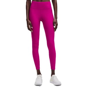 Bright pink high-waisted leggings paired with white sneakers.