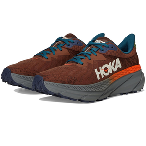 Hoka running shoes featuring a brown and orange color scheme with blue laces and a thick gray sole, designed for comfort and support.