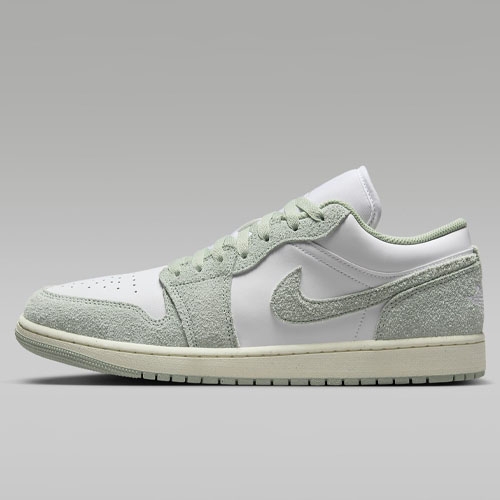 A green and white Nike Air Jordan 1 Low sneaker with a suede texture on the upper.