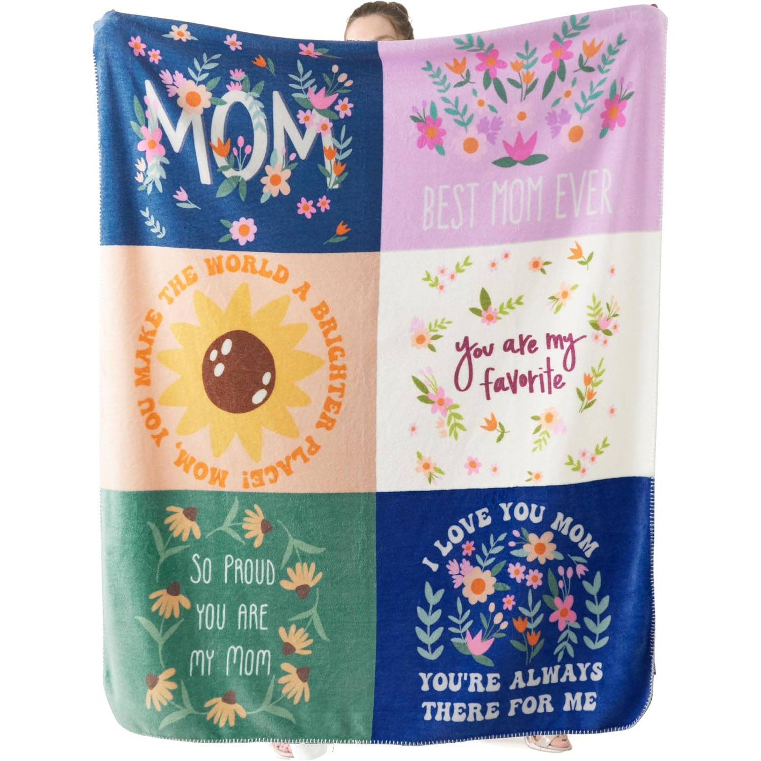 A colorful patchwork blanket featuring floral designs and heartwarming messages for Mom, such as \“Best Mom Ever,\“ \“You are my favorite,\“ and \“I love you Mom.\“