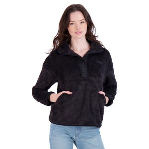 Black fuzzy pullover with a half-button front, high collar, and front kangaroo pocket, paired with light blue jeans.