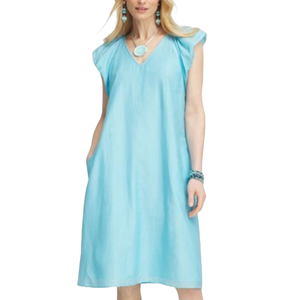 A light blue, mid-length dress made of cotton-silk voile. It features a V-neckline, flutter sleeves, and two side pockets. Accessorized with turquoise jewelry.