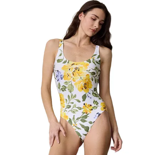A one-piece swimsuit with a floral design featuring large yellow flowers and green leaves on a white background.