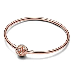 A rose gold bracelet featuring a minimalist design with a small knot-like detail, adorned with a single clear gemstone.
