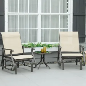 Two beige outdoor glider chairs with armrests are positioned around a small round black glass table, set on a gray patio in front of a window with a flower box.