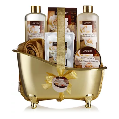 A gift set featuring white rose and jasmine-scented items, including shower gel, bubble bath, body scrub, bath salts, and a towel, all packed in a gold, bathtub-shaped container with a decorative ribbon.