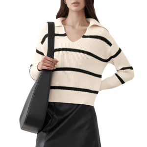 A cream-colored, long-sleeve Johnny-collar sweater with black stripes, paired with a black leather skirt and a large black shoulder bag.