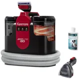 The photo shows a Kenmore Spotlite Go portable carpet cleaner with a hose, a cleaning solution, and an attachment tool.