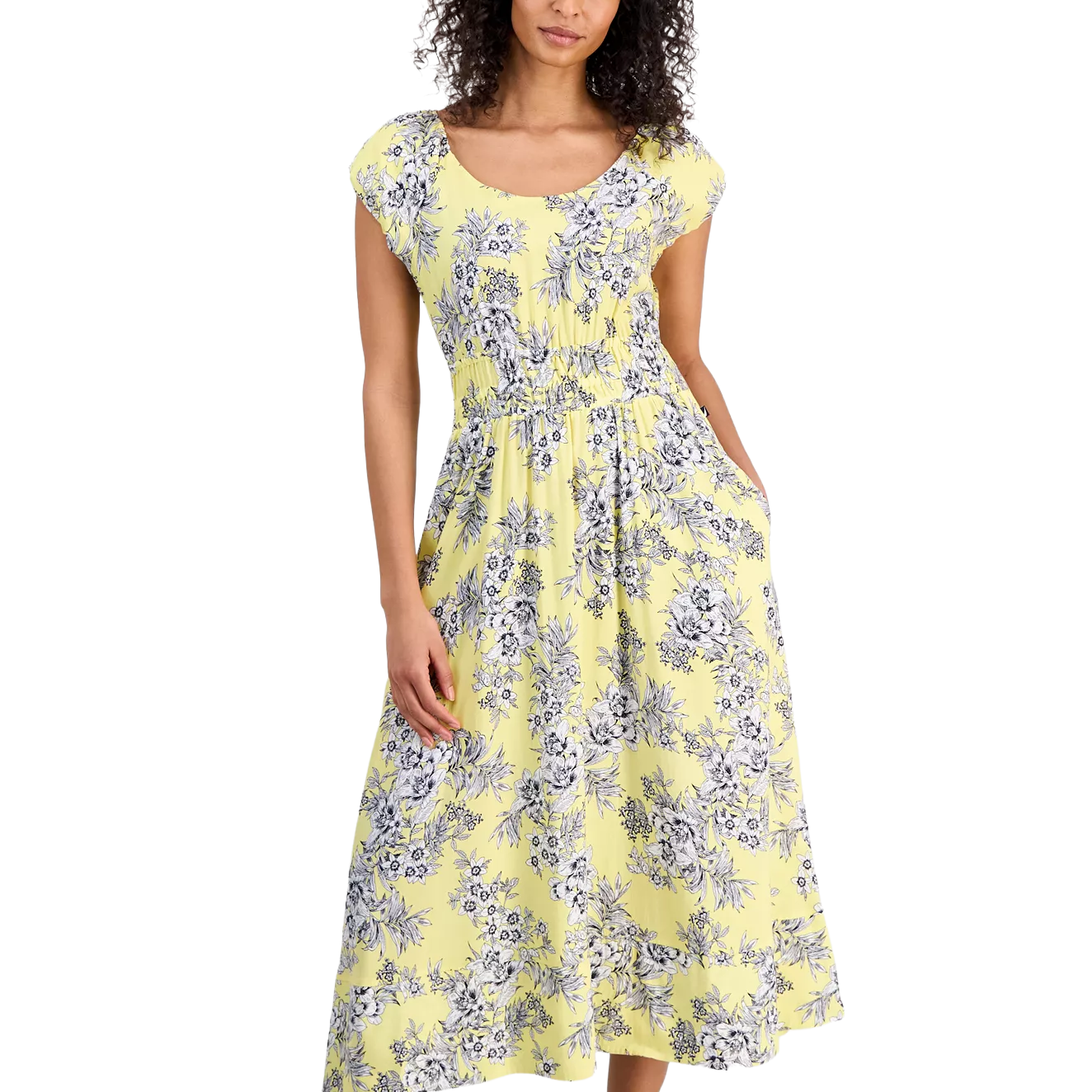 A woman wears a yellow floral midi dress with short sleeves and a gathered waist, featuring a pattern of blue and white flowers.