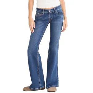 Blue flared jeans with front pockets and a button closure, paired with beige boots.