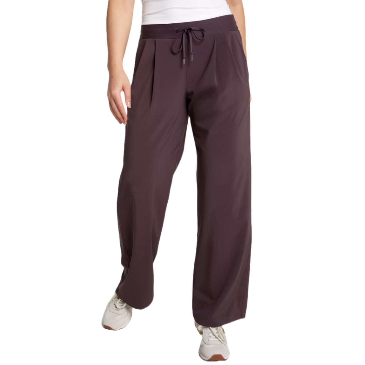 Dark brown drawstring pants paired with white sneakers.