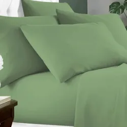A green bedding set featuring neatly arranged pillows and sheets on a bed.