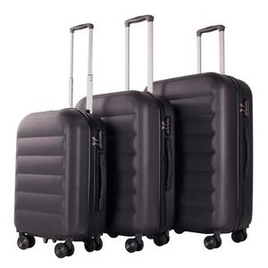 A set of three black hardside suitcases with telescopic handles and four spinner wheels each, featuring a sleek ribbed design. Sizes vary for different travel needs, offering practical and durable luggage options.