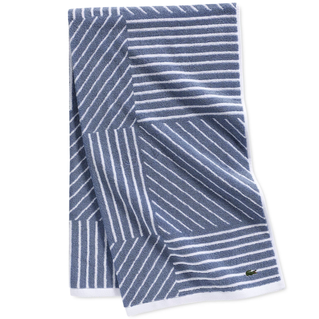 Blue and white striped towel with a geometric pattern and a small logo.