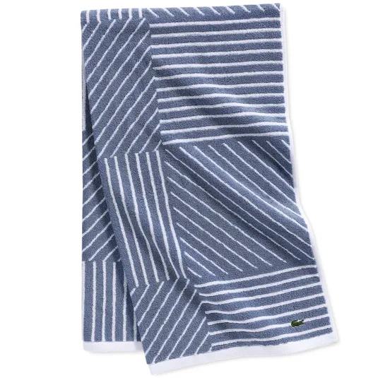 Blue and white striped towel with a geometric pattern and a small logo.
