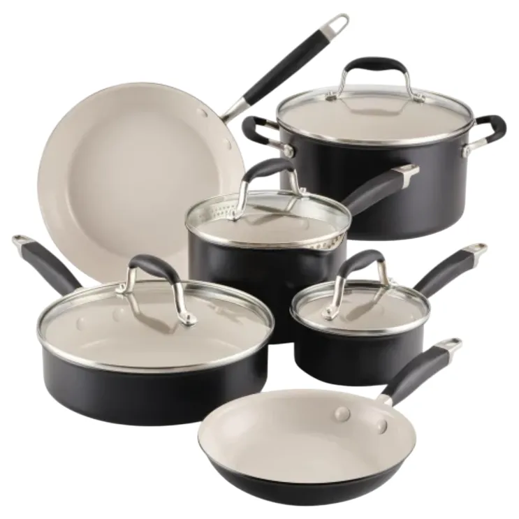 A set of black cookware with ceramic interiors, including various pots and pans with glass lids and black handles.