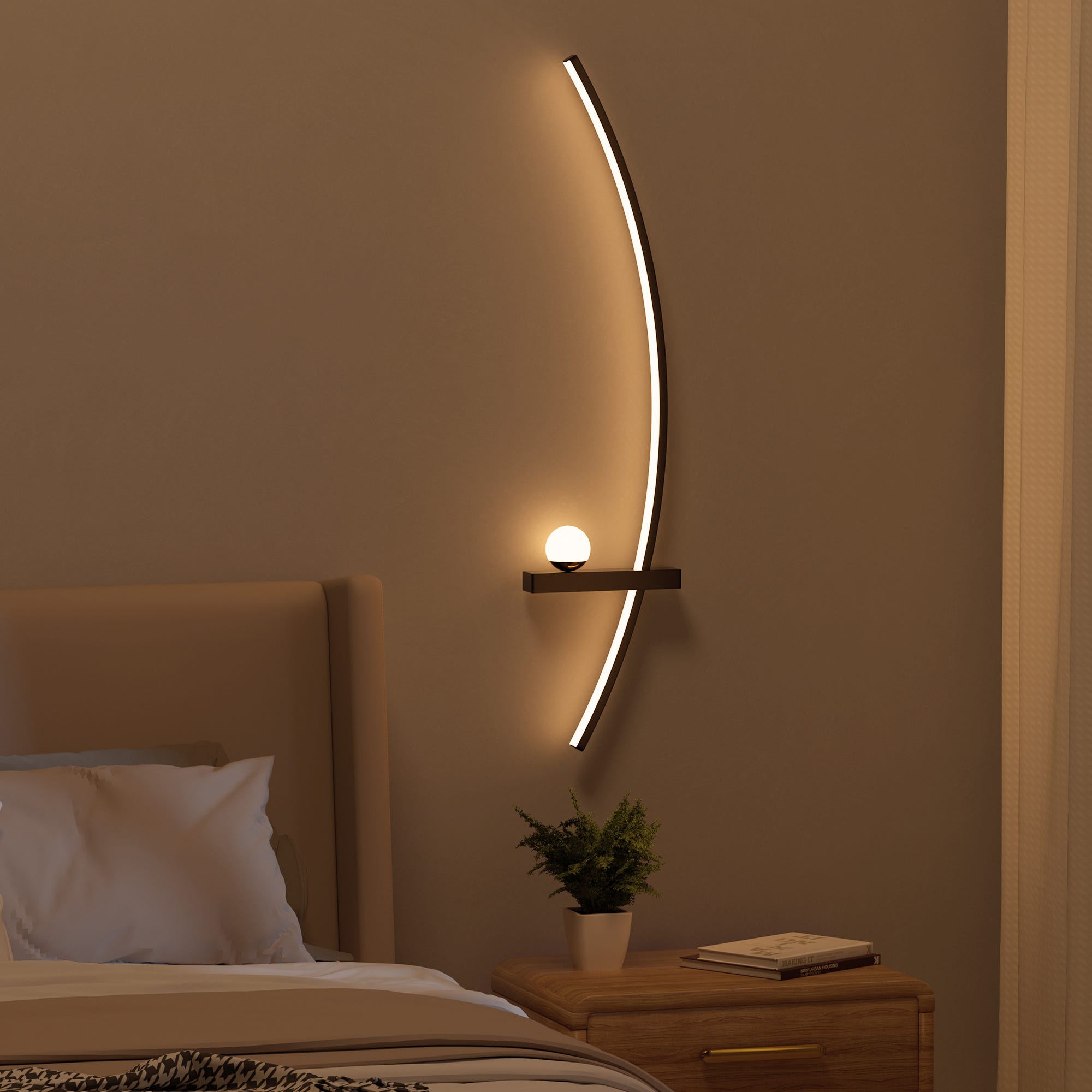 Modern curved wall light above a bedside table with a round bulb and a potted plant.