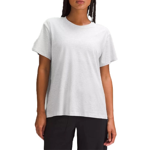 A relaxed-fit white cotton t-shirt with short sleeves and a classic crew neckline, paired with black pants.