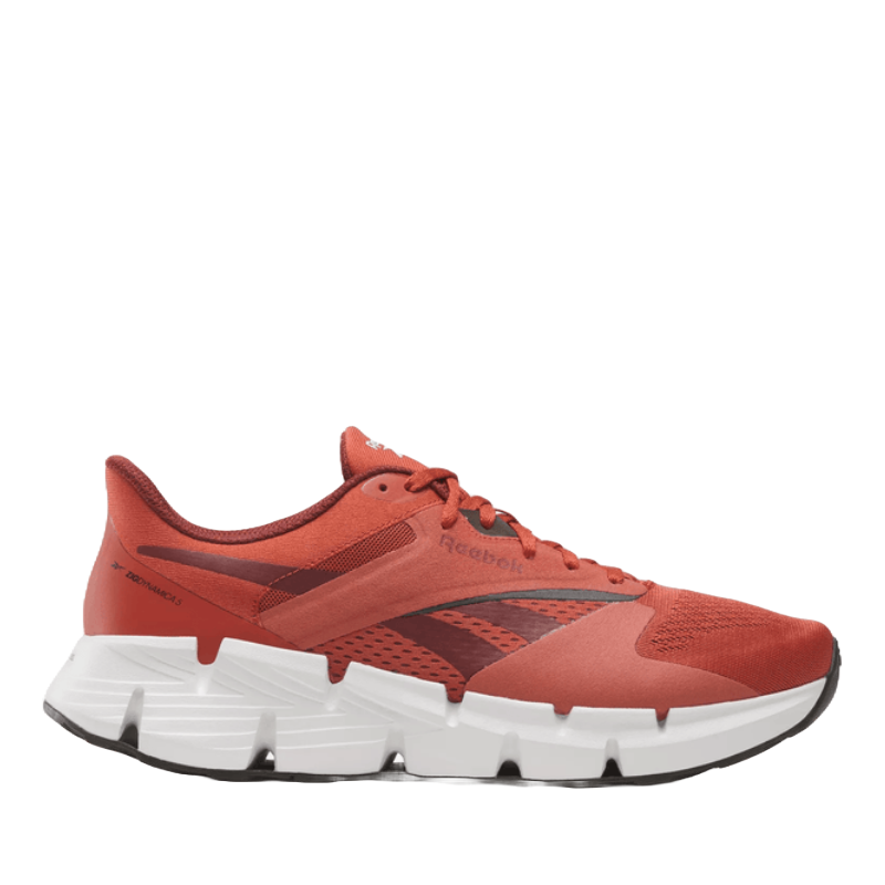Reebok Zig Dynamica 5 Shoes feature a vibrant red design with a breathable mesh upper and distinctive zigzag midsole for cushioning. The outsole is durable with a textured grip, providing a stylish and functional athletic option.