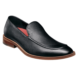 A black leather slip-on shoe with a textured finish features a brown sole and a red interior lining.