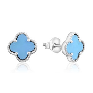 Silver stud earrings with a clover shape, featuring a blue inlay and decorative bead edging.