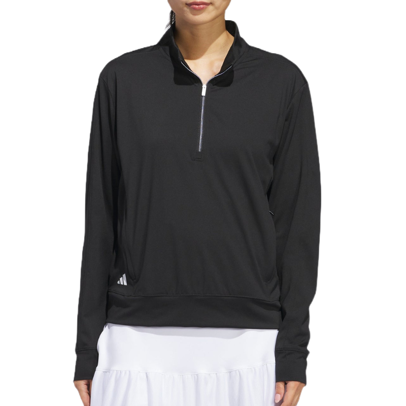 Adidas Half-Zip Layering Jacket in black features a lightweight, long-sleeve design with a half-zip closure and a logo on the bottom side. Ideal for layering in various activities.