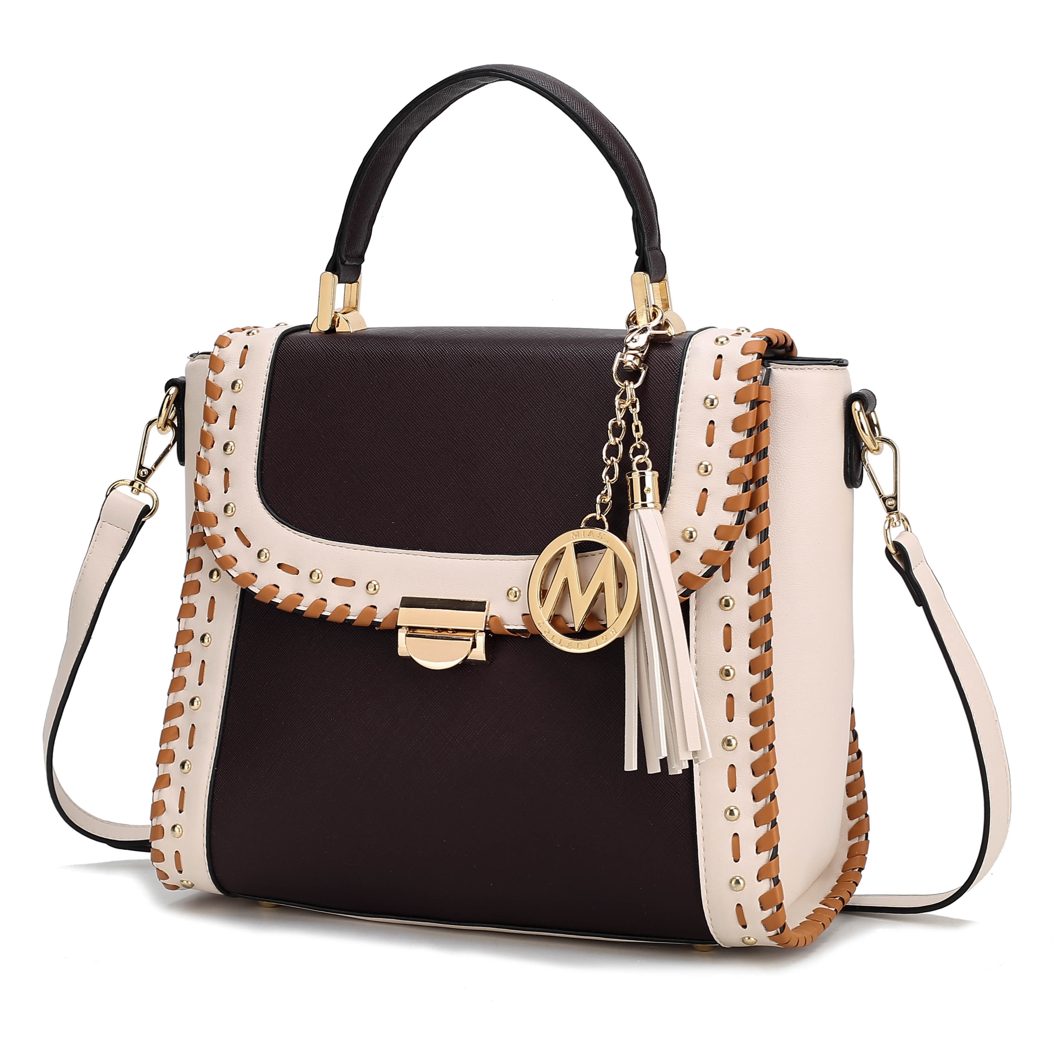 A stylish handbag with a black and white color scheme, featuring a top handle, detachable shoulder strap, stud detailing, and decorative charm with a tassel and circular emblem.