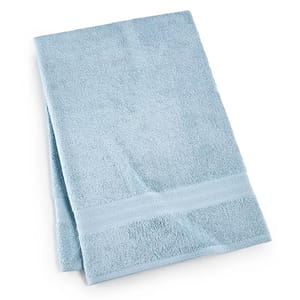 A folded light blue bath towel with a decorative border.