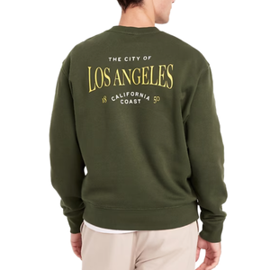 A person is wearing a dark green sweatshirt with yellow text saying \“The City of Los Angeles, California Coast 1850\“ on the back.