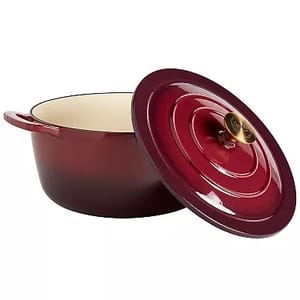A 7-quart Dutch oven with a glossy burgundy exterior and cream-colored interior, featuring a matching lid with a gold-tone knob.