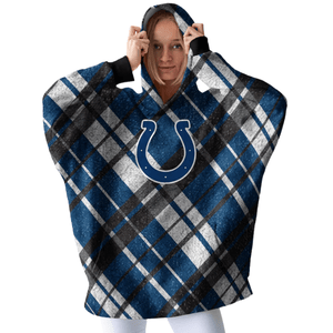 A person wears a plaid hooded blanket with a blue horseshoe logo, likely from a sports team, featuring colors of blue, white, and black.