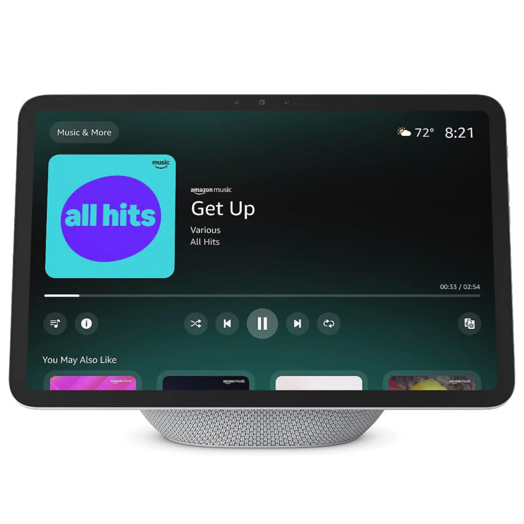 A smart display with a music interface showing \“Get Up\“ from \“All Hits\“ on Amazon Music, featuring controls for playback and recommendations. The time is 8:21, and the temperature is 72°F.