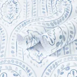 Blue and white paisley-patterned wallpaper with a swirling leaf design, featuring a textured appearance.