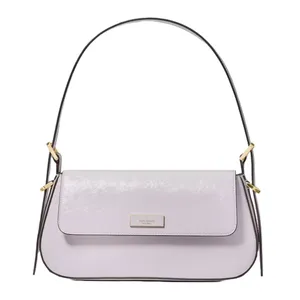 A light purple shoulder bag with gold hardware accents and a curved design. The bag features a flap closure and a structured handle.