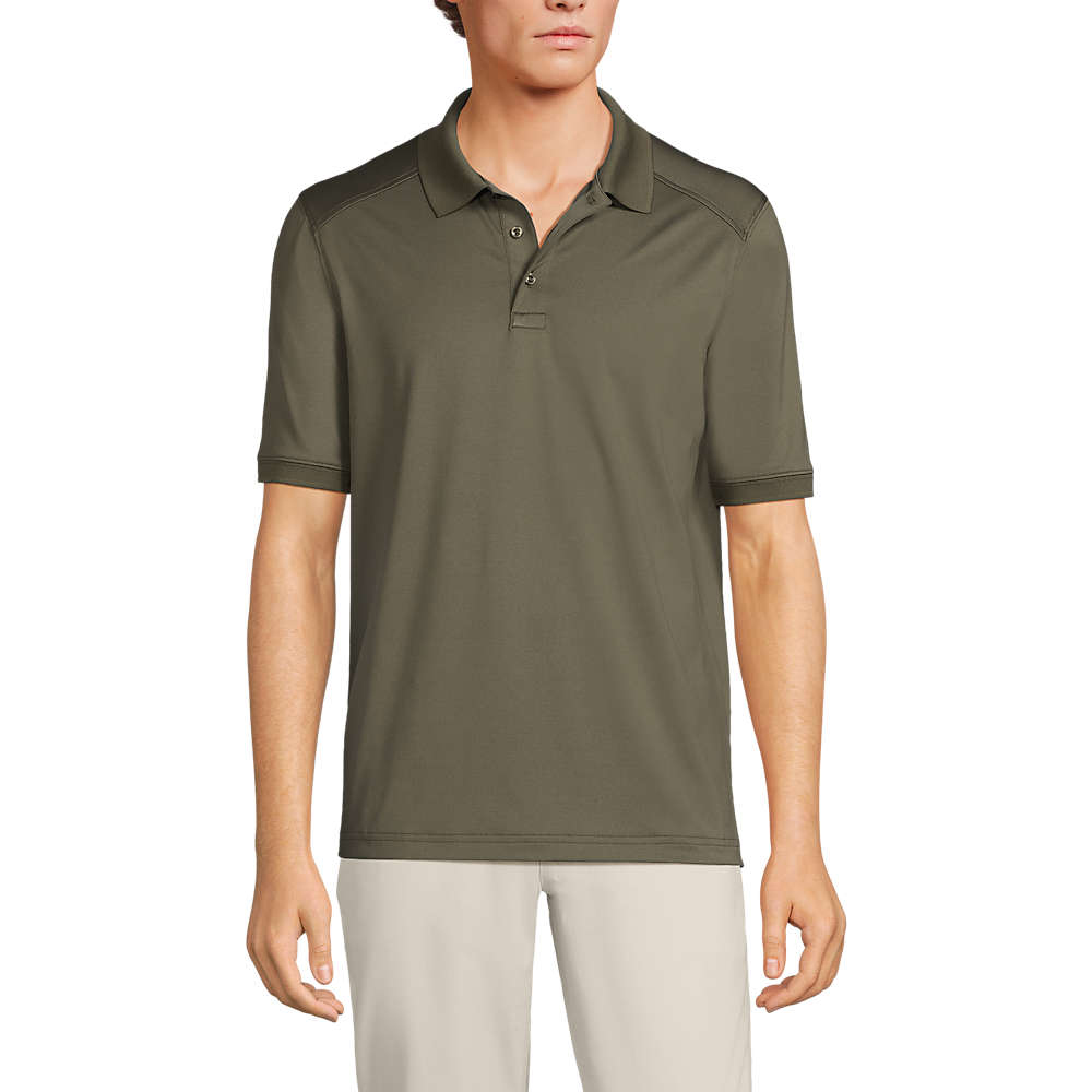 A man is wearing an olive green short-sleeve polo shirt paired with light-colored pants against a white background.