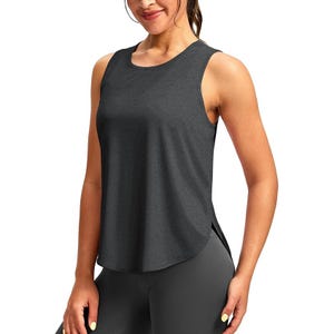 Sleeveless, dark gray athletic tank top paired with dark leggings.