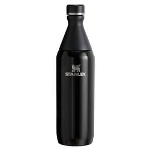 A black Stanley stainless steel water bottle with a tapered, detachable top and logo in the center.