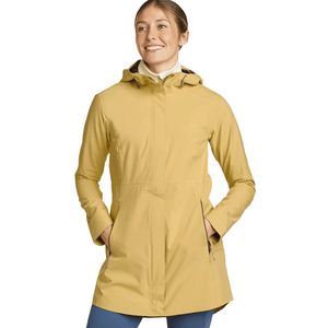A woman is wearing a mustard-yellow hooded coat, featuring front pockets and a full zip.