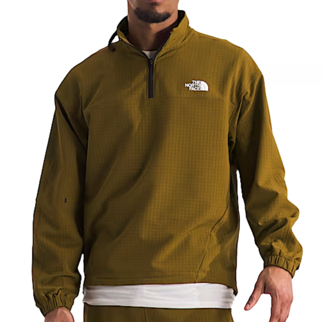 The North Face Grid Fleece Jacket is an olive green pullover with a quarter-zip design, featuring a high collar and elastic cuffs. The North Face logo is visible on the left chest.