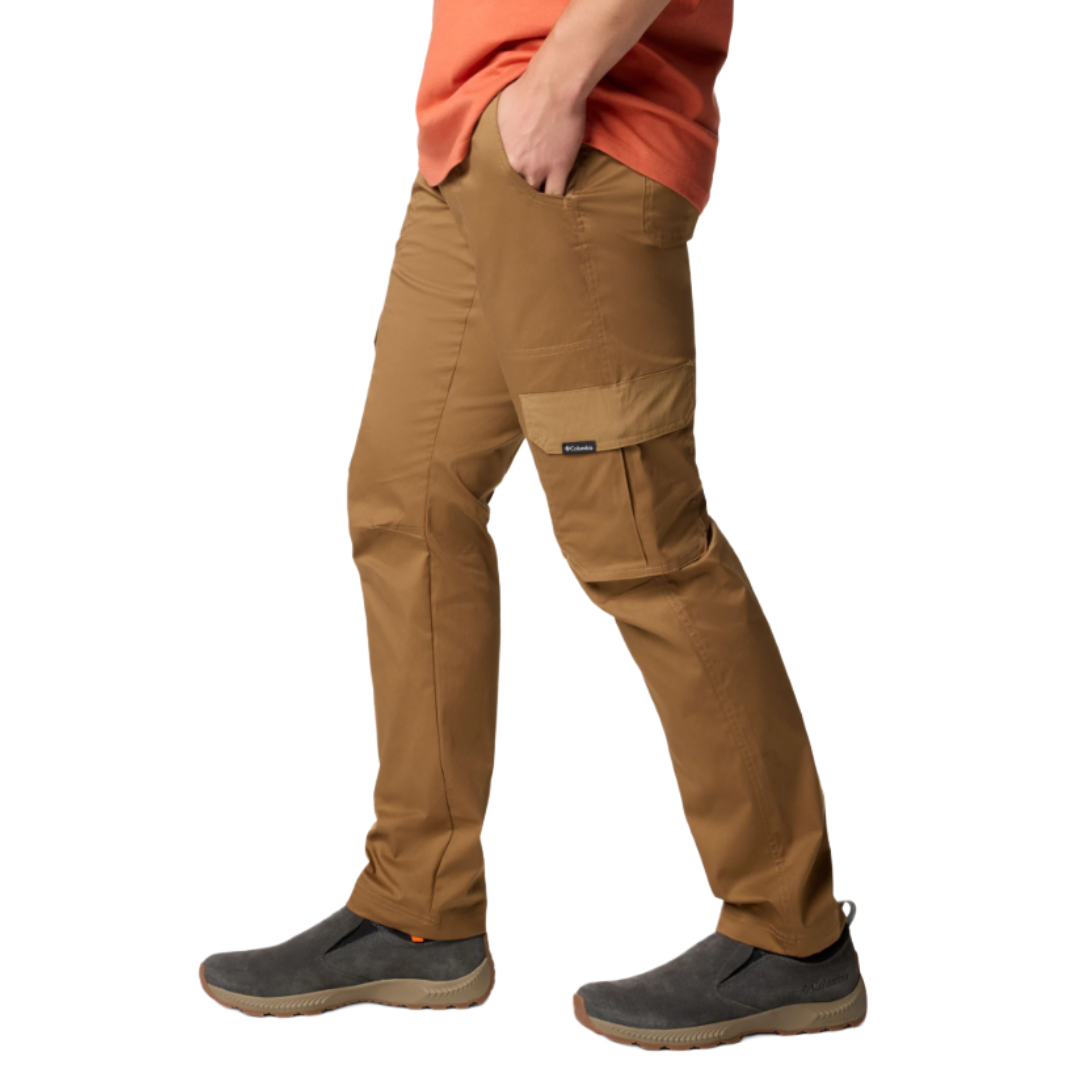 A person wearing brown cargo pants with a side pocket and gray slip-on shoes featuring tan soles.