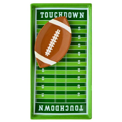 A rectangular chip and dip set designed like a football field, with \“TOUCHDOWN\“ at each end. The set includes a football-shaped dish centered on the field-themed tray.