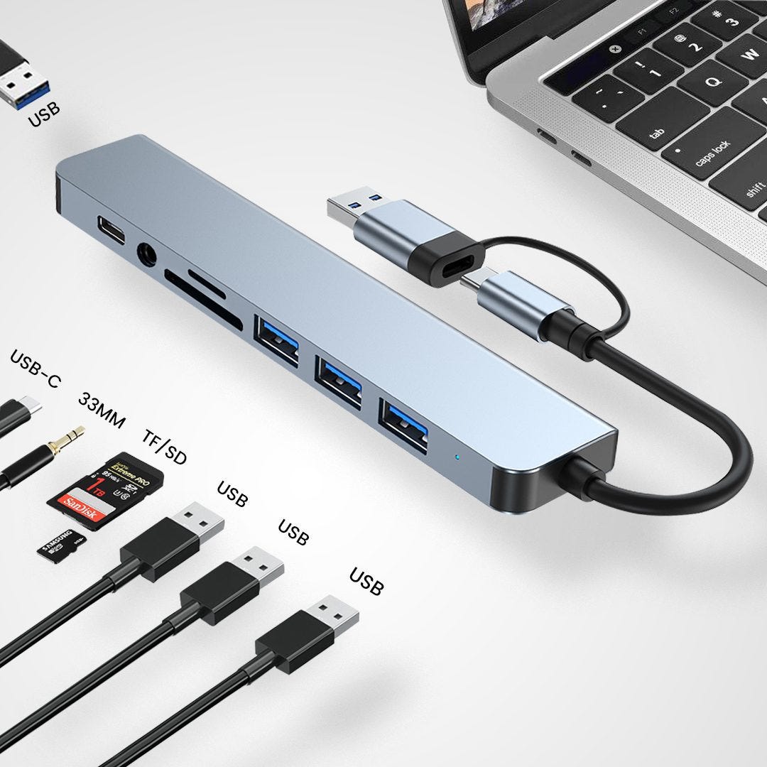 A sleek, silver 8-in-1 USB-C hub with multiple ports including HDMI, USB 3.0, and SD card slots, connected to a laptop.